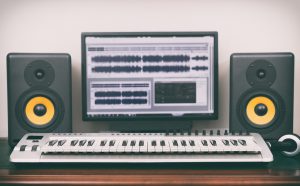 Home recording studio with professional monitors and midi keyboard.